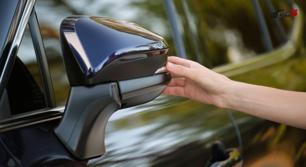 An hand adjusting car side mirror.