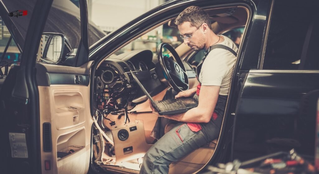 A person checking car with laptop 