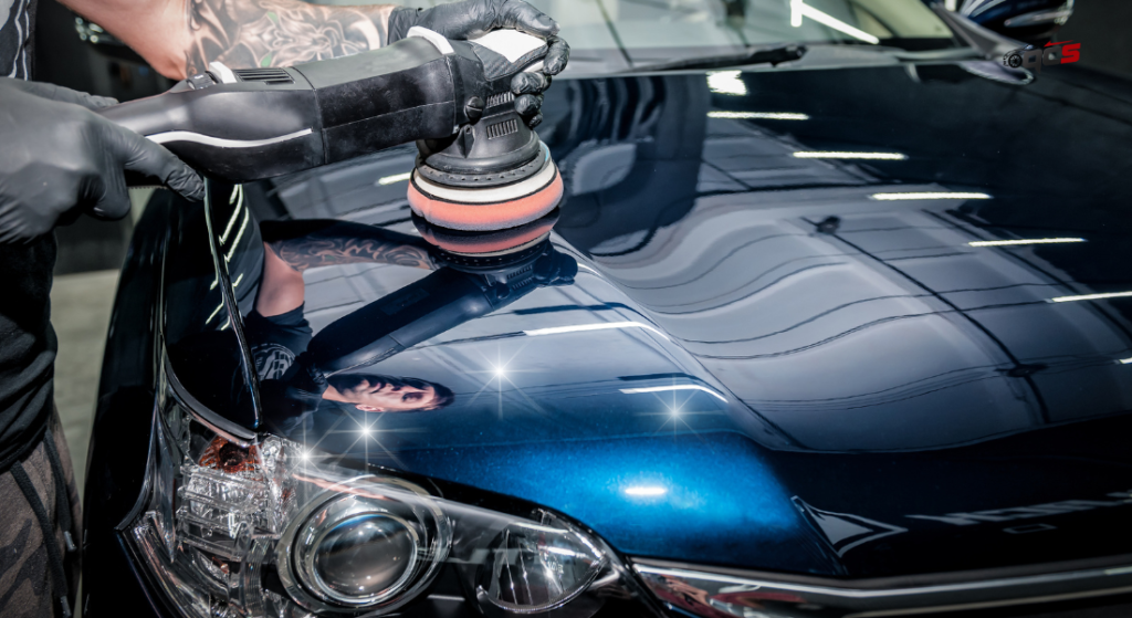 A person polishing or waxing a car